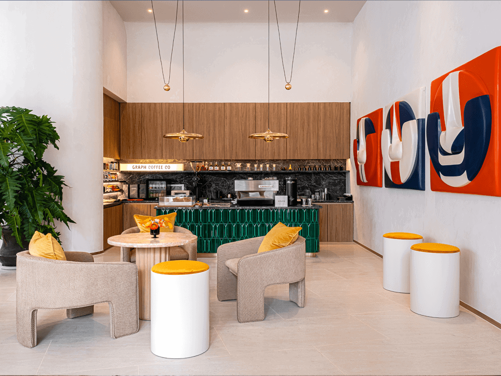 Bright interior of a Bangkok cafe featuring contemporary art, comfortable chairs, and a stylish coff.