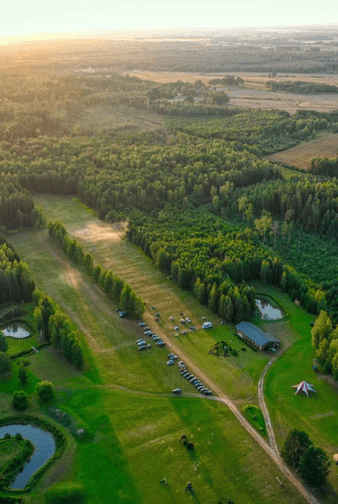 Farm for sale in Latvia with lush green fields and scenic landscapes.