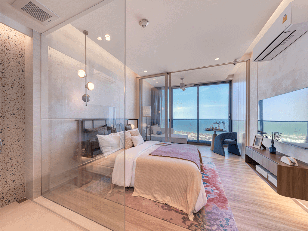 Sea view bedroom in Hua Hin, Thailand with stylish decor and glass walls.
