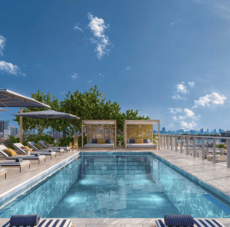 Modern rooftop pool in Miami with sun loungers and city views.