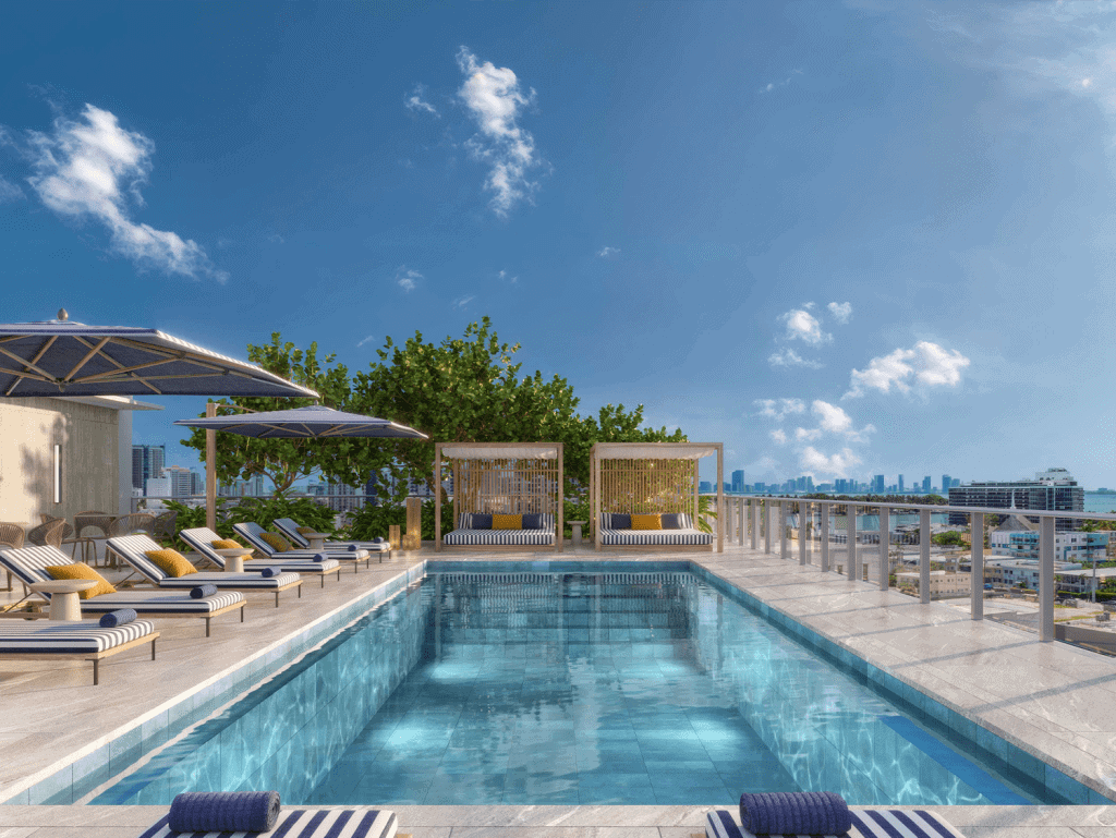 Modern rooftop pool in Miami with sun loungers and city views.