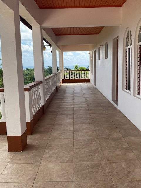 Spacious living room with balcony access in Portland Port Antonio, Jamaica. Perfect for a luxurious.