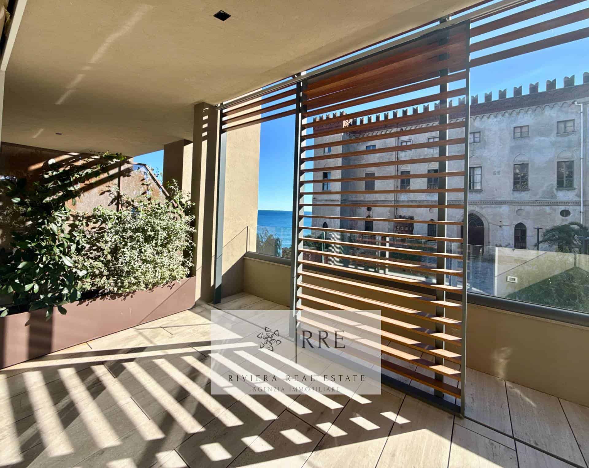 Balcony with ocean view, wooden slats for privacy, and outdoor space in a coastal property.