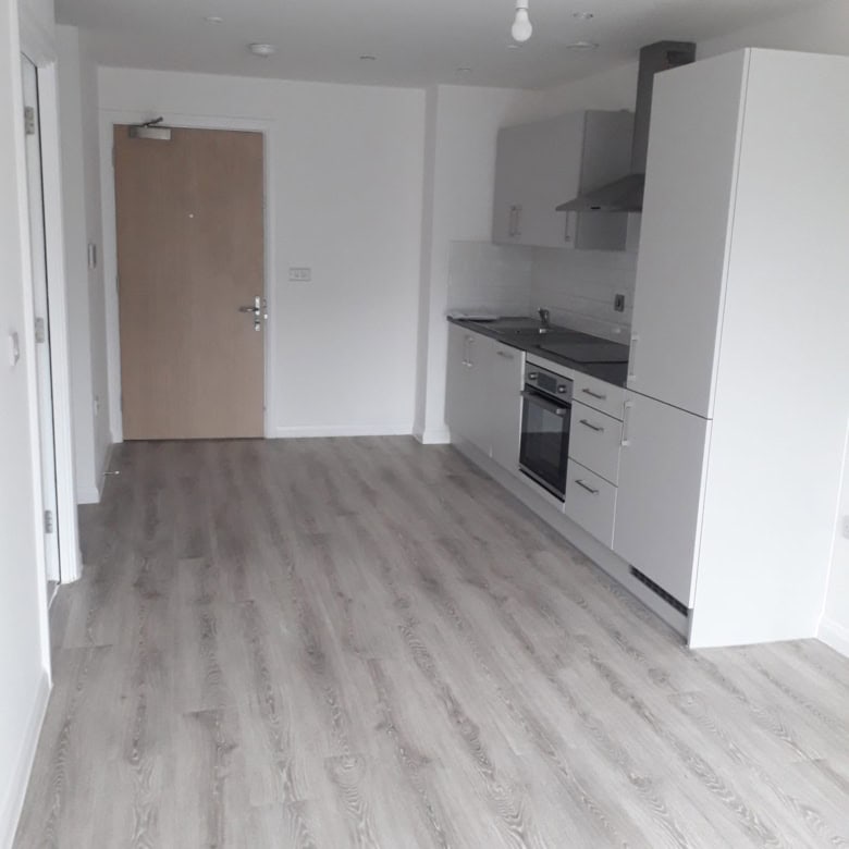 Modern 1 bedroom apartment in Birmingham, West Midlands, UK, featuring a sleek kitchen and open livi.