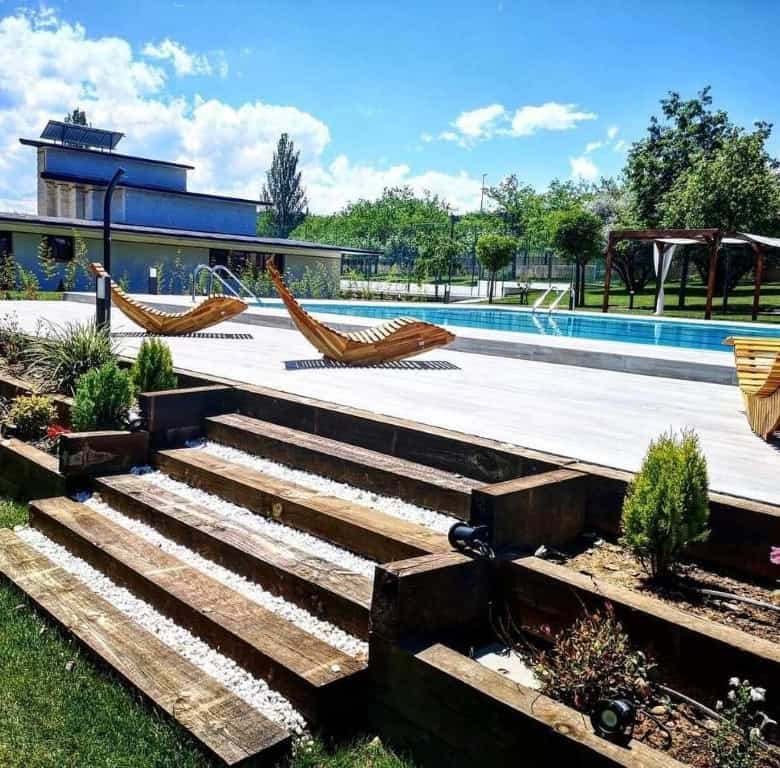 Luxury Finca Vivaldi Hotel for sale in Leon, Spain, featuring a modern pool and outdoor lounging spa.