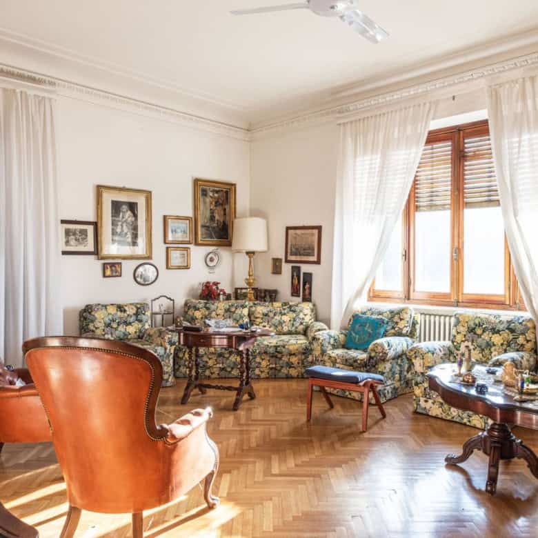 Elegant living room with vintage furniture and natural light.