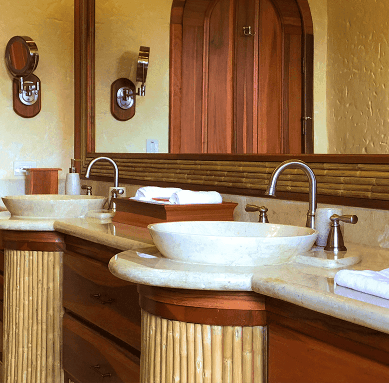 Elegant bathroom with dual sinks and rustic wooden accents in Arenal Hills, La Fortuna, Costa Rica.