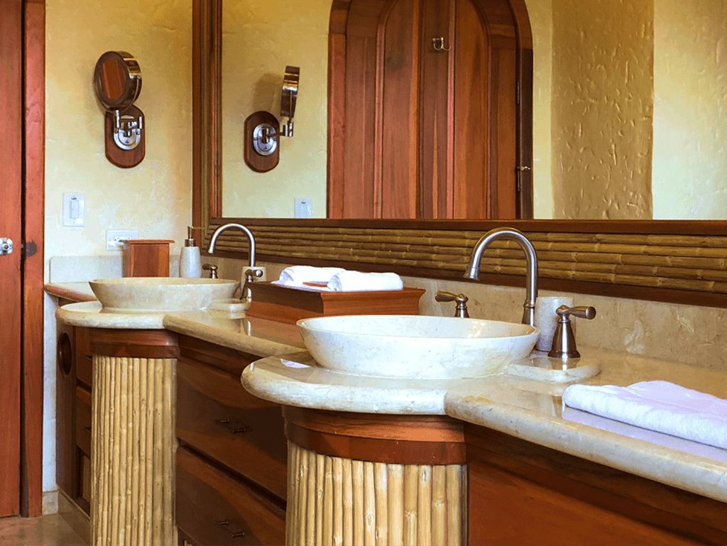 Elegant bathroom with dual sinks and rustic wooden accents in Arenal Hills, La Fortuna, Costa Rica.