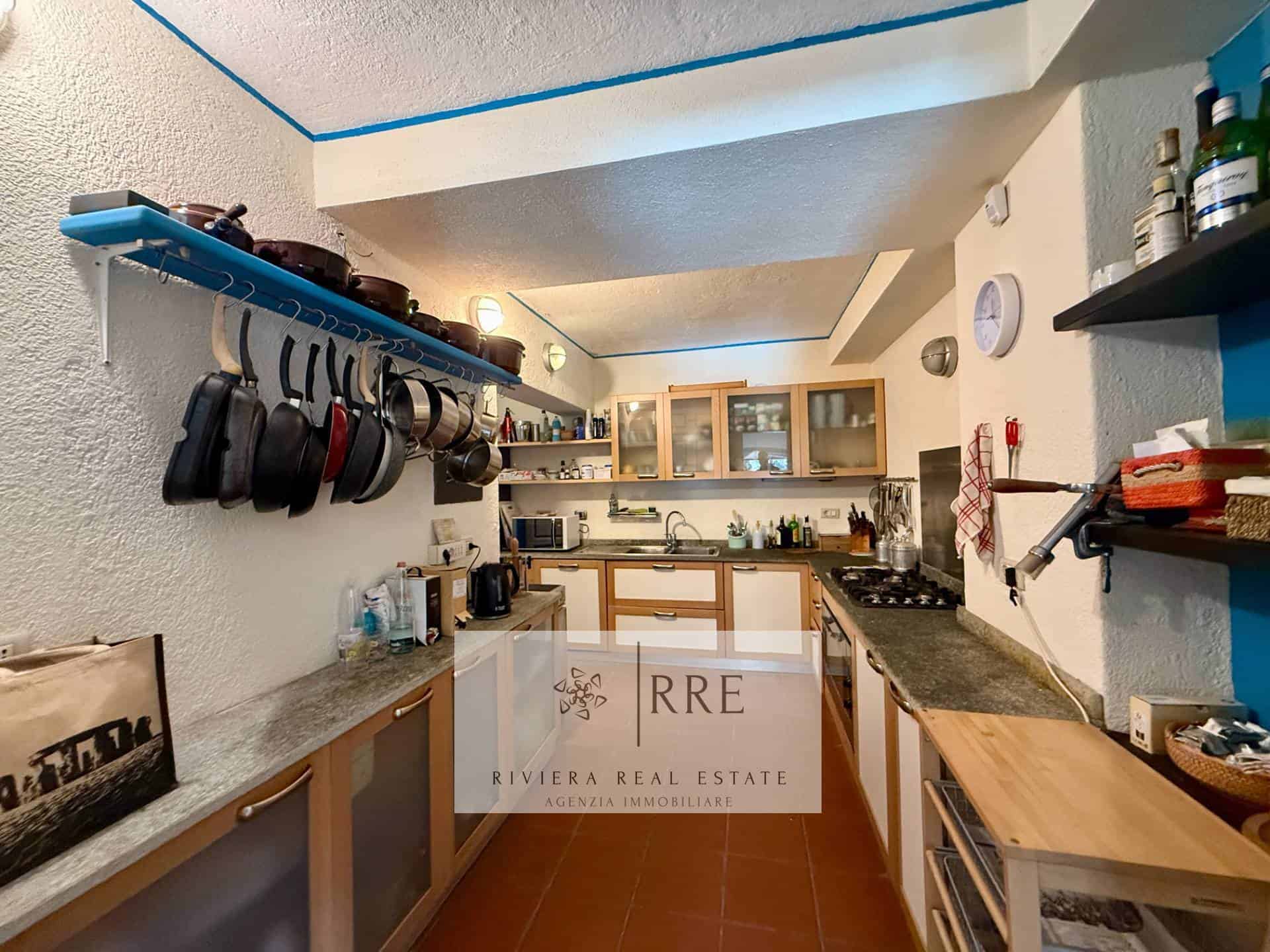Modern kitchen with open shelves, appliances, and cozy decor.