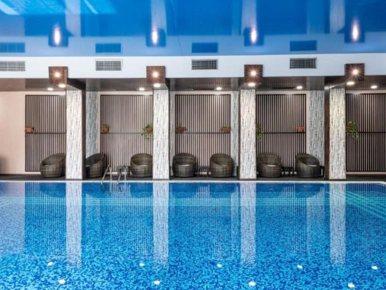 Indoor pool with cabanas and relaxing atmosphere in St. Vlas.