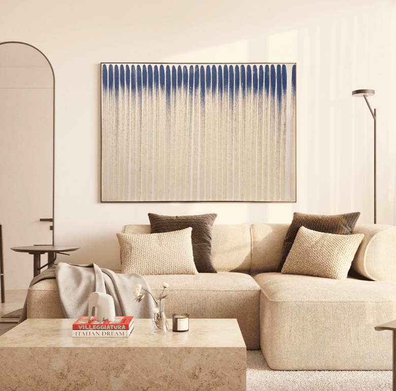 Elegant living room with comfortable sofa, artwork, and contemporary lighting.