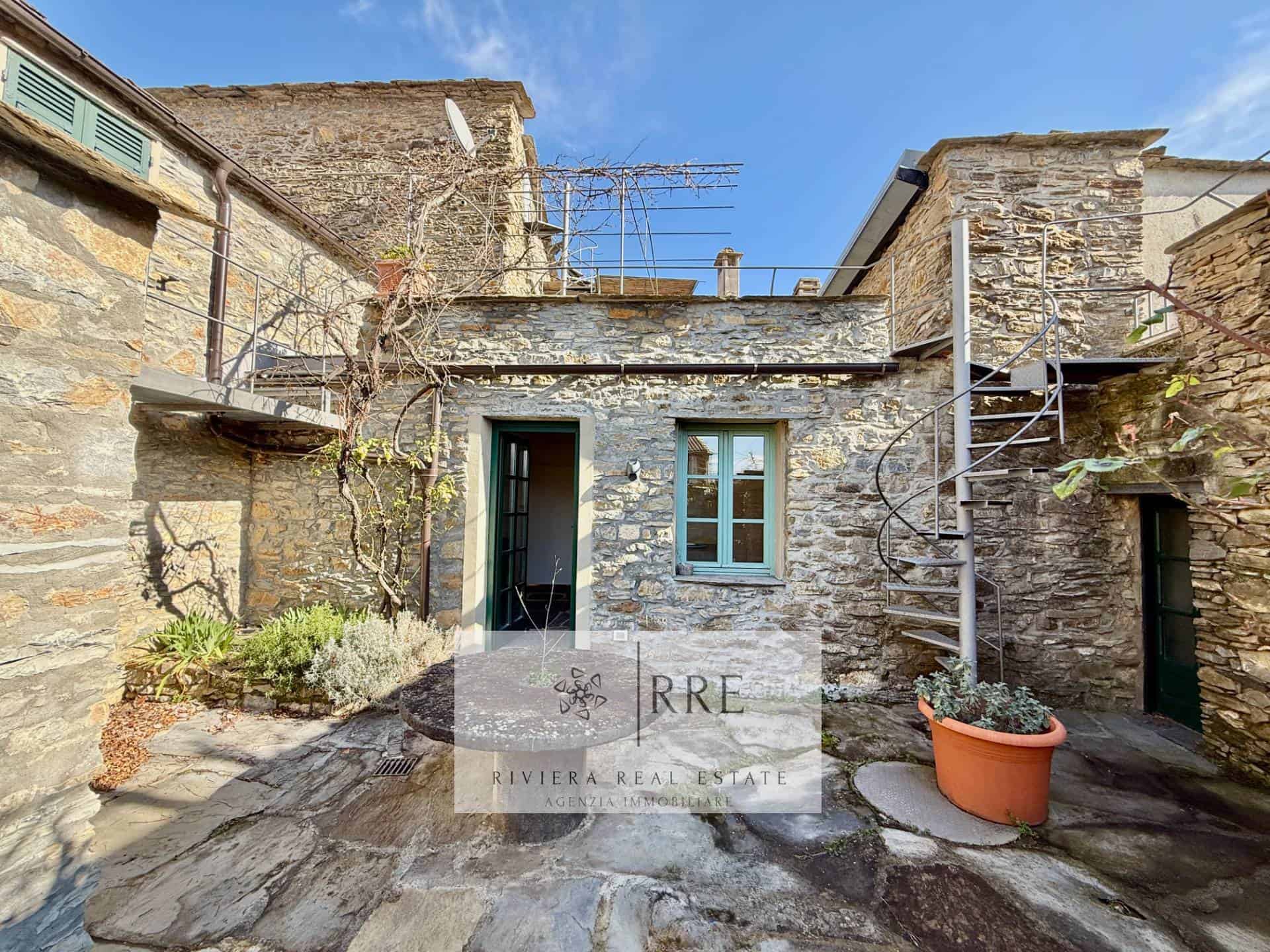 Charming stone cottage with outdoor patio in a historic village.