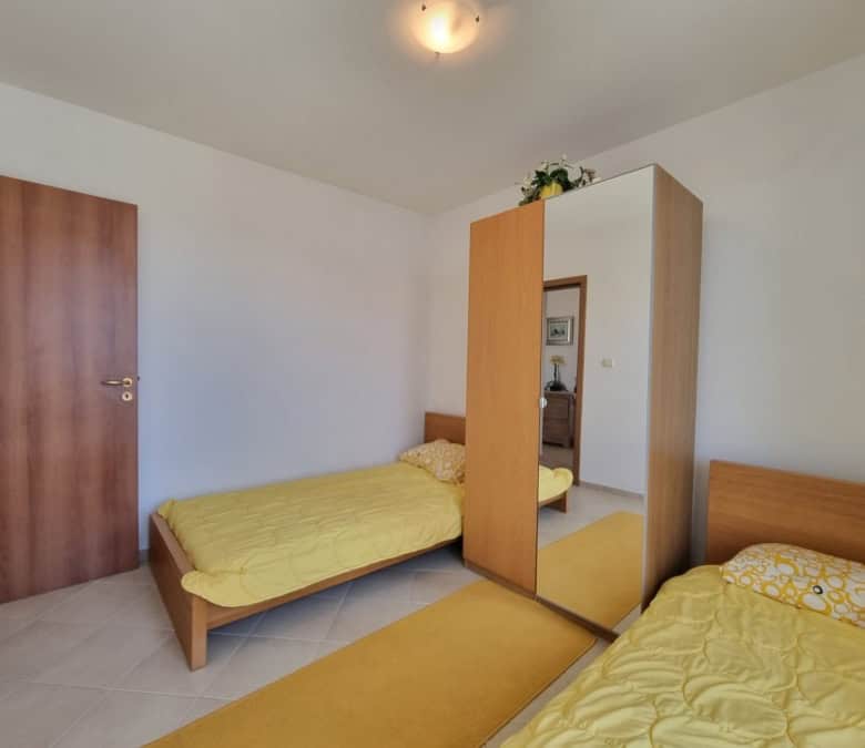 Spacious bedroom with twin beds and wardrobe in a modern home near Sunny Beach.