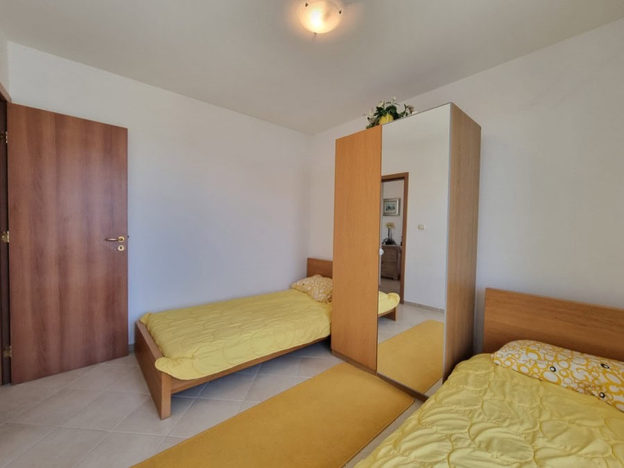 Spacious bedroom with twin beds and wardrobe in a modern home near Sunny Beach.