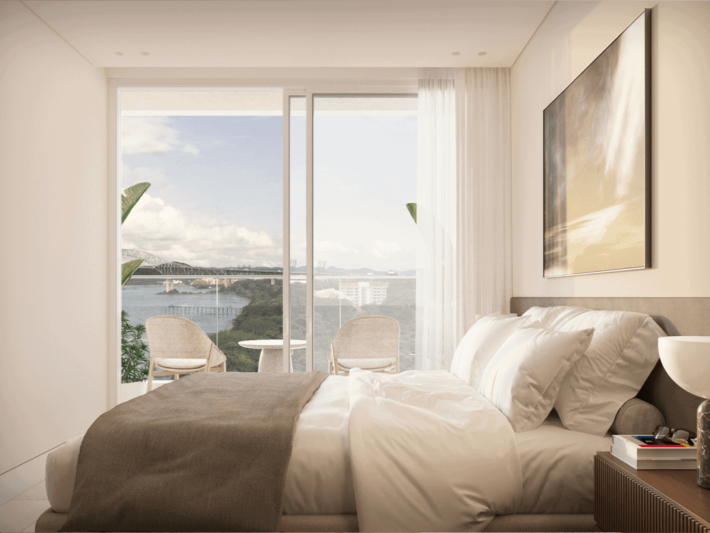 Modern bedroom with balcony overlooking Panama City skyline and water views.