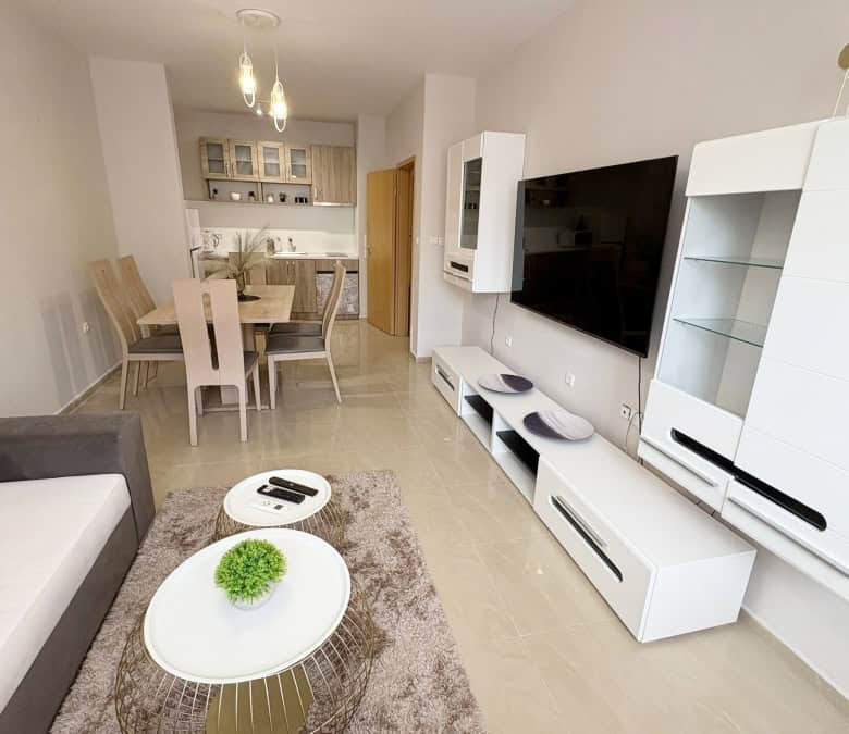 Modern living room with TV and stylish furniture in Sunflower complex.