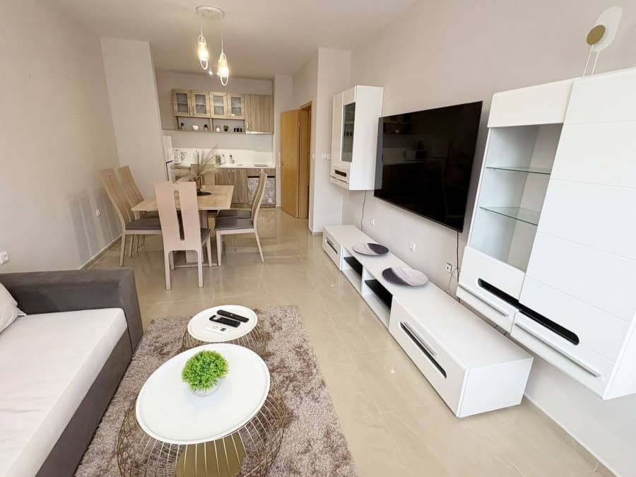 Modern living room with TV and stylish furniture in Sunflower complex.
