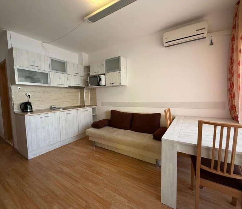 Cozy 2-bedroom apartment with living area, kitchen, and dining space near Sunny Beach.