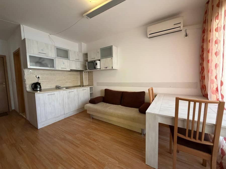 Cozy 2-bedroom apartment with living area, kitchen, and dining space near Sunny Beach.