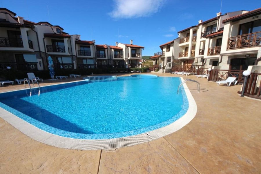 Modern apartment complex with pool at Imperial Heights, Sunny Beach. Pool area at Imperial Heights, Sunny Beach with residential buildings in the background.