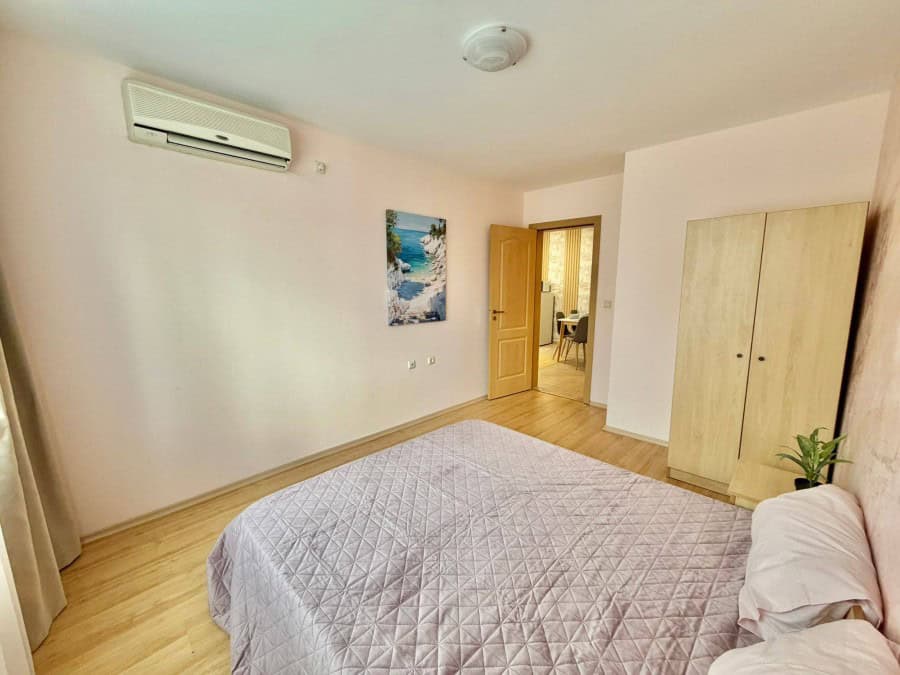 Bright 2-bedroom apartment in Sveti Vlas with mountain views, near the sea, featuring a spacious bed.