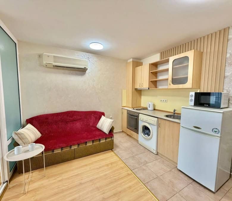 Interior view of a 2-bedroom apartment in Sveti Vlas, featuring a cozy living area and compact kitch.