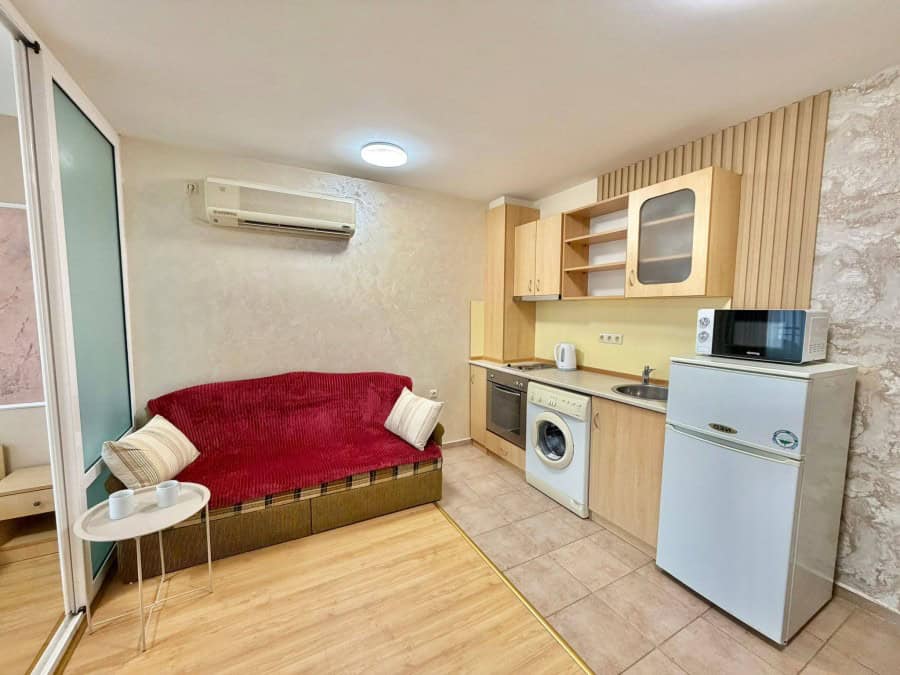 Interior view of a 2-bedroom apartment in Sveti Vlas, featuring a cozy living area and compact kitch.