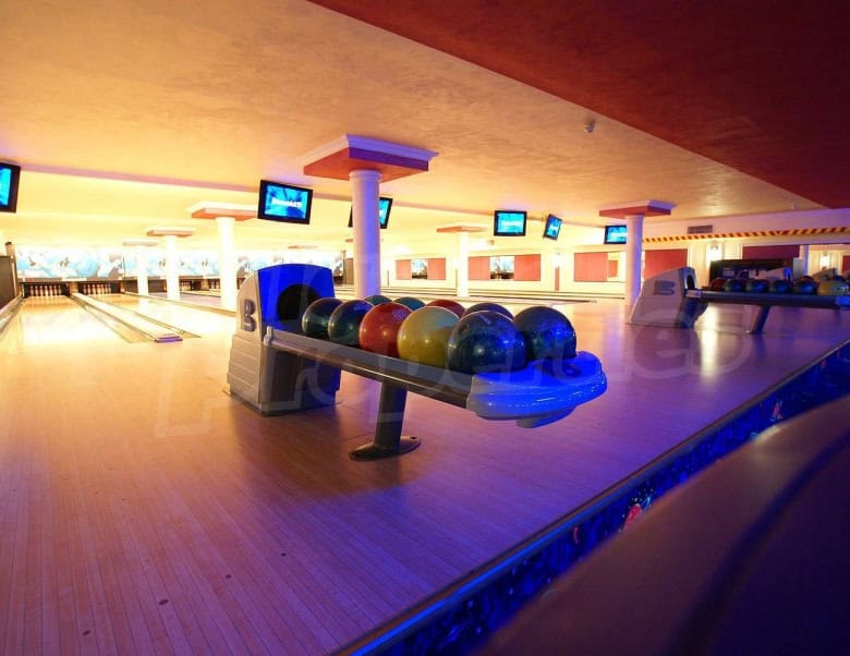 Indoor bowling alley at Sunset Resort, Pomorie, featuring vibrant lanes and modern equipment.