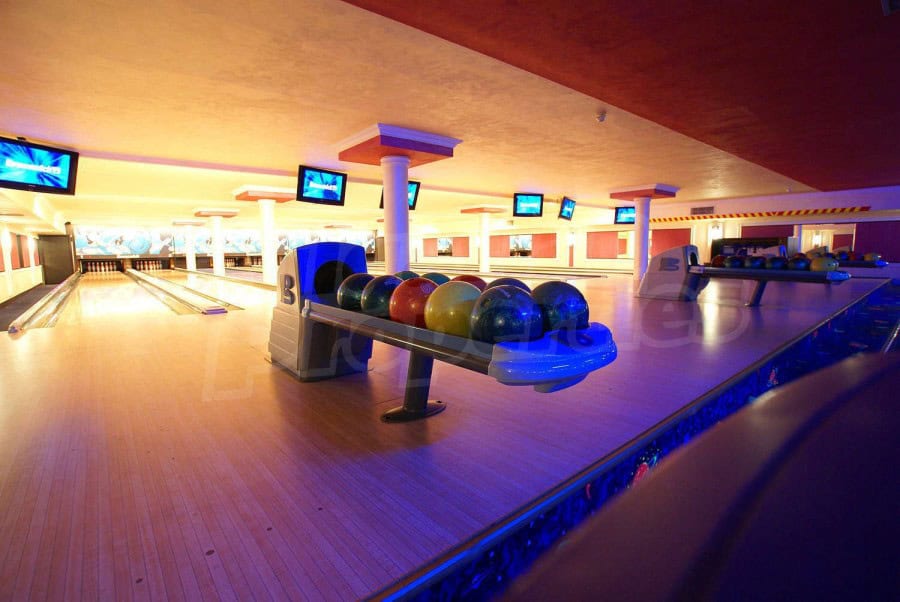 Indoor bowling alley at Sunset Resort, Pomorie, featuring vibrant lanes and modern equipment.
