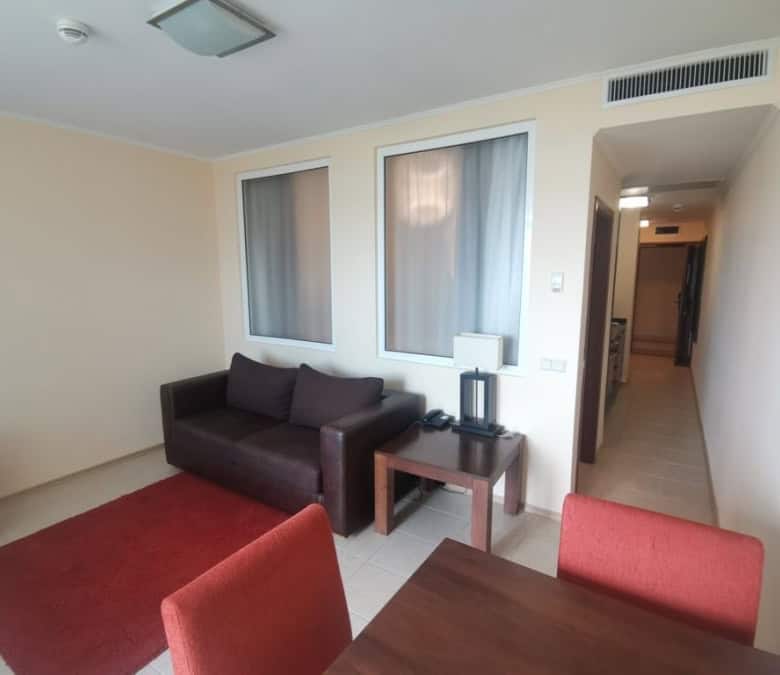 Sea view 1-bedroom apartment in Sunset Resort, Pomorie, with modern furnishings and balcony.