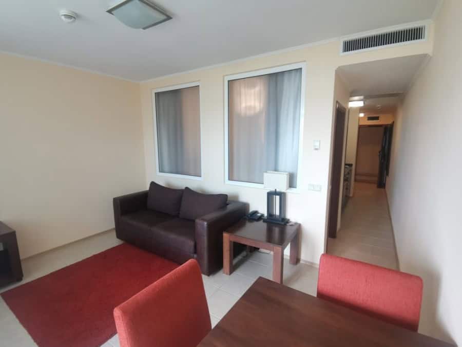 Sea view 1-bedroom apartment in Sunset Resort, Pomorie, with modern furnishings and balcony.