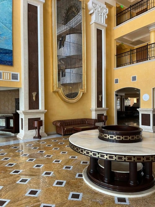 Elegant hotel lobby with high ceilings and ornate decor.