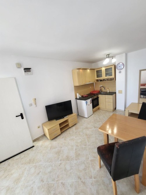 Apartment interior with living area, kitchen, and dining space in Sunset Kosharitsa.