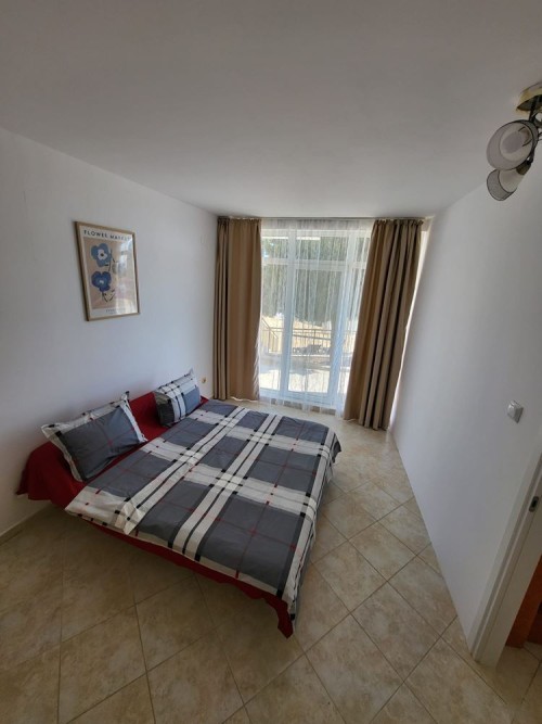 Apartment with bedroom, large window, and balcony in Sunset Kosharitsa.