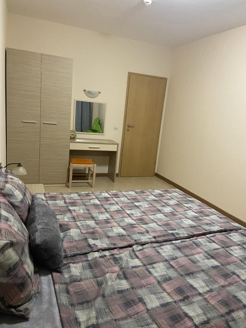 Interior of a 1-bedroom apartment with a large bed, wardrobe, and dressing table in Sunny Beach, Bul.