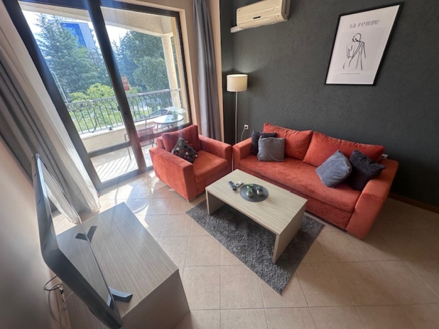 Bright living room with a balcony overlooking greenery in Royal Sun, Sunny Beach, Bulgaria.