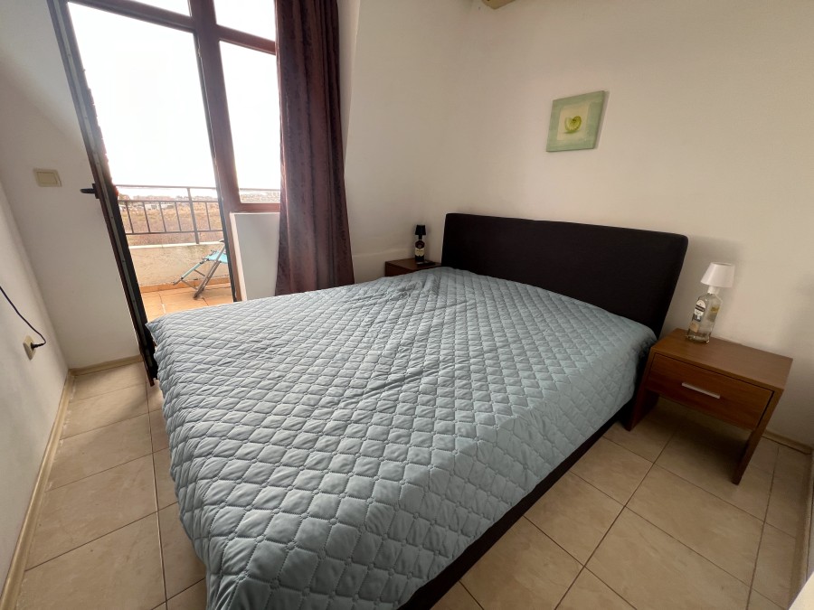 Bright bedroom with balcony overlooking the sea, pool, and mountains in Nessebar outskirts. Perfect.