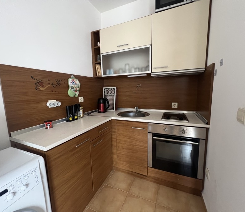 Cozy kitchen in a 2-bedroom apartment with sea, pool, and mountain views near Sunny Beach.