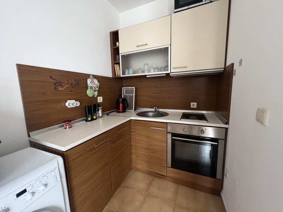Cozy kitchen in a 2-bedroom apartment with sea, pool, and mountain views near Sunny Beach.