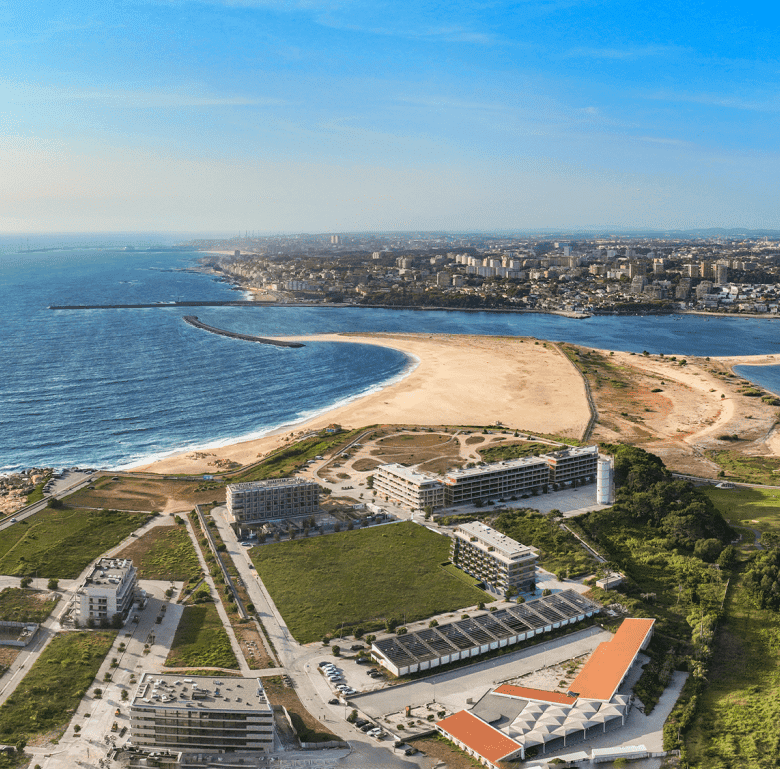 Aerial view of Sal D'ouro in Porto, Portugal, showcasing the beachfront, modern buildings, and sceni.