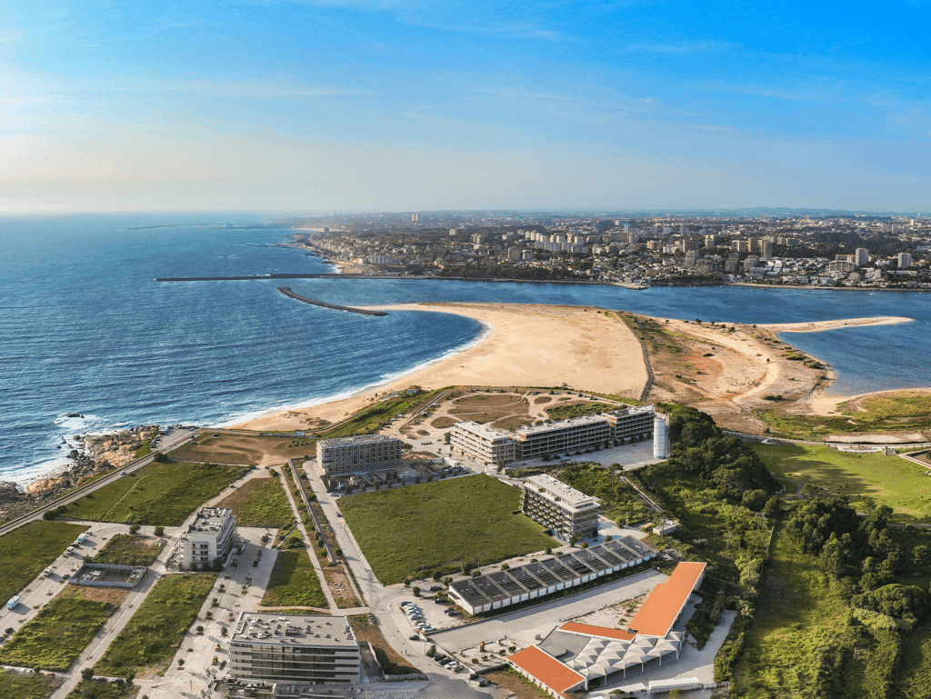Aerial view of Sal D'ouro in Porto, Portugal, showcasing the beachfront, modern buildings, and sceni.