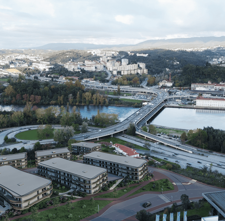 Heritage - Coimbra, Portugal: A scenic view of the city with modern apartments, bridges, and lush gr.