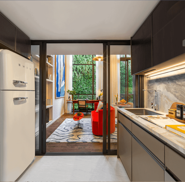 Contemporary Bangkok apartment kitchen featuring sleek cabinetry, marble backsplash, and bright natu.