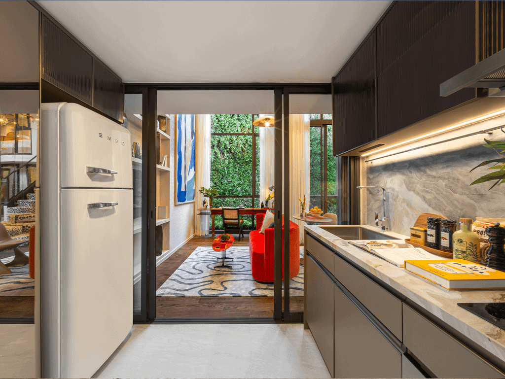 Contemporary Bangkok apartment kitchen featuring sleek cabinetry, marble backsplash, and bright natu.