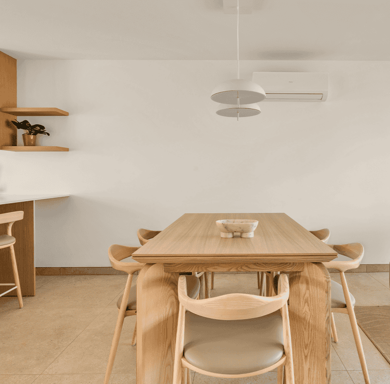 Contemporary dining room in Carvoeiro, Algarve with minimalist design and natural wood furniture.