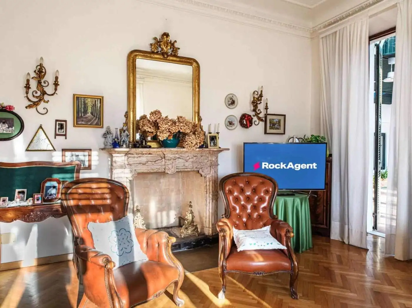 Elegant living room with vintage decor and fireplace in a luxury villa in Varzi, Italy.