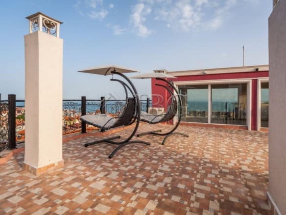 Rooftop terrace featuring stylish hanging lounge chairs overlooking the sea in Sveti Vlas.