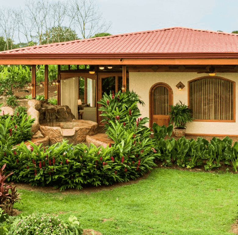 Beautiful garden view of a Costa Rican home with lush greenery and tropical plants.
