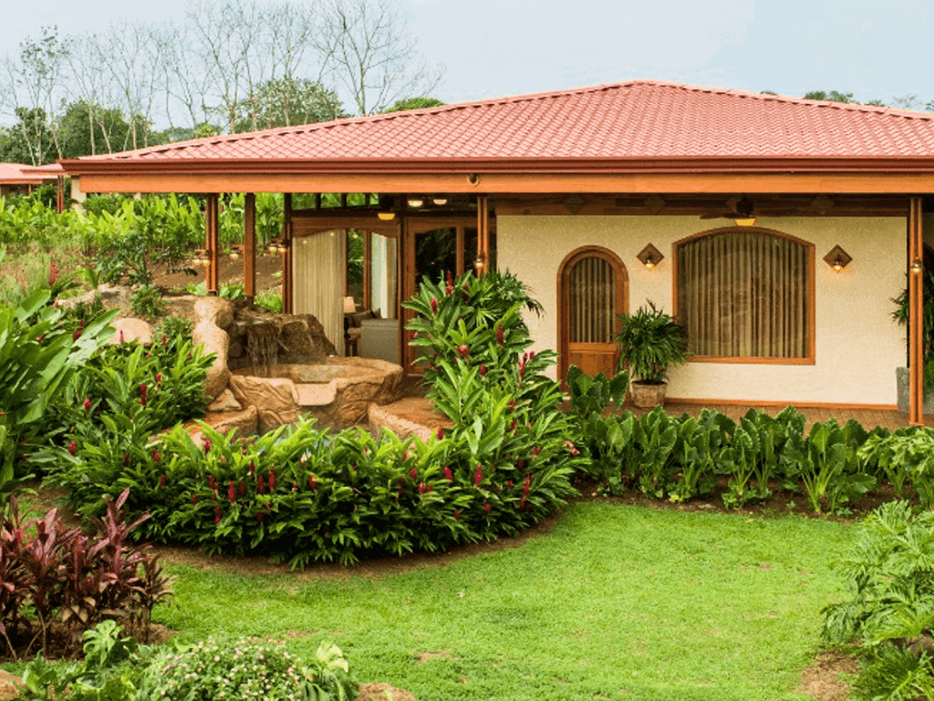 Beautiful garden view of a Costa Rican home with lush greenery and tropical plants.