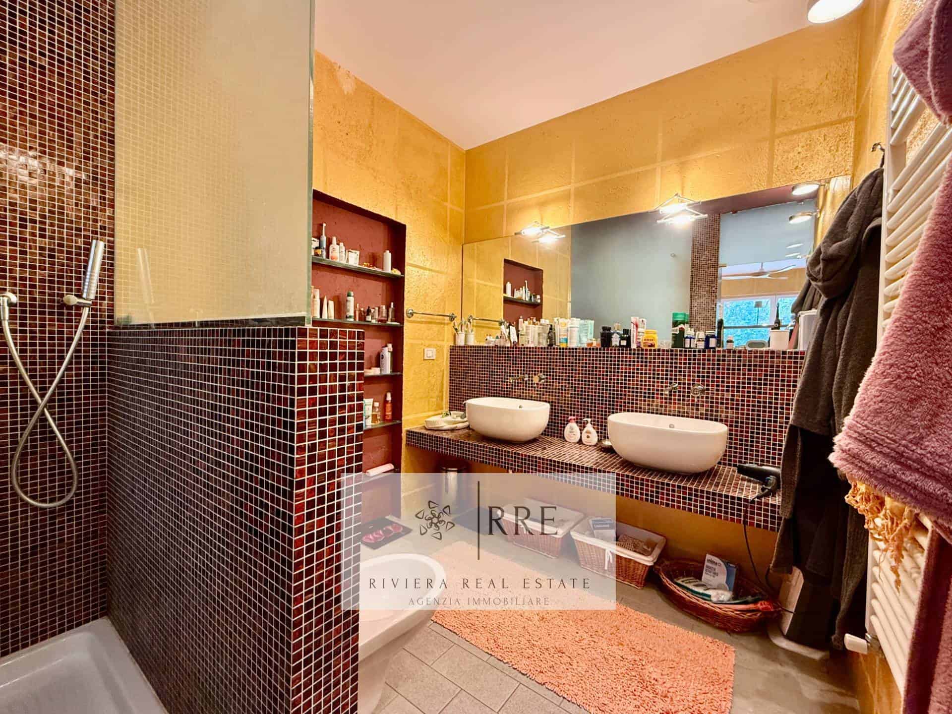 Modern bathroom with double sinks and shower area for comfort and style.